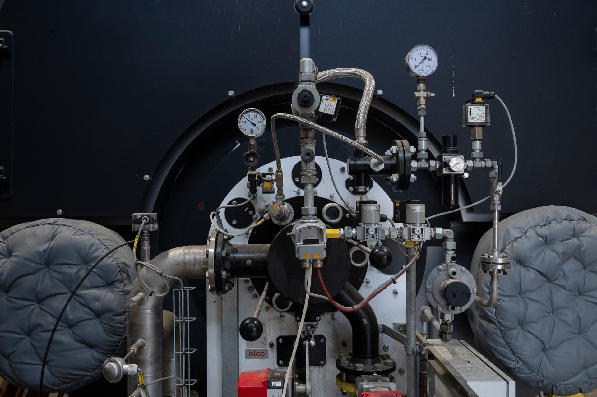 Close-up of process installation with pressure gauges and valves at the Empro plant